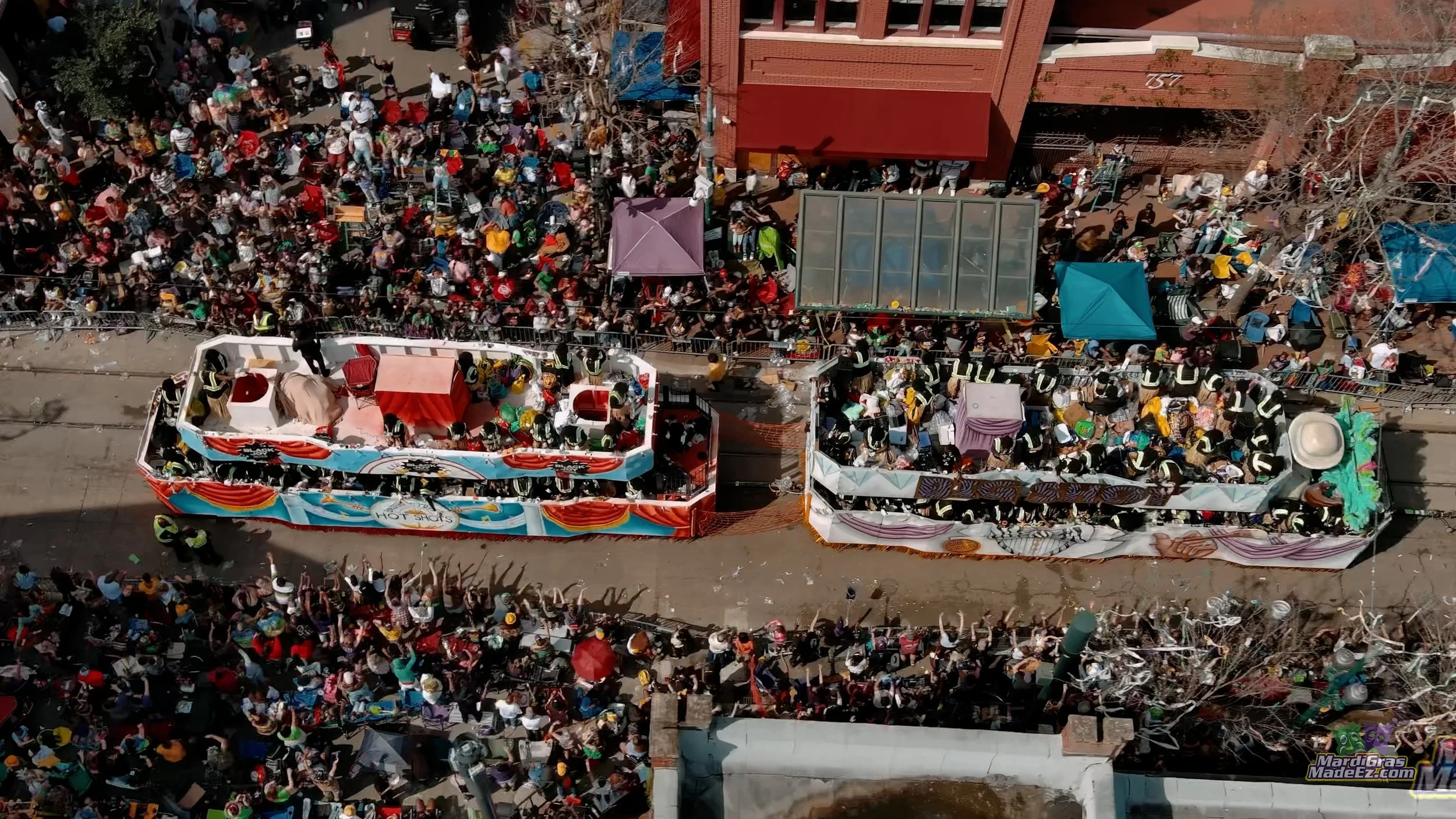 An overhead view of a parade float and crowds lining the street